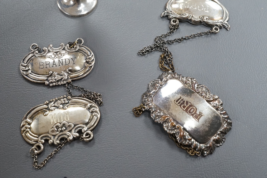 A modern silver wine funnel, with shell thumbpiece, L.J. Millington, Birmingham, 2000, 13.4cm, together with a small silver pedestal cup, three assorted sterling wine labels and three other wine labels including two plat